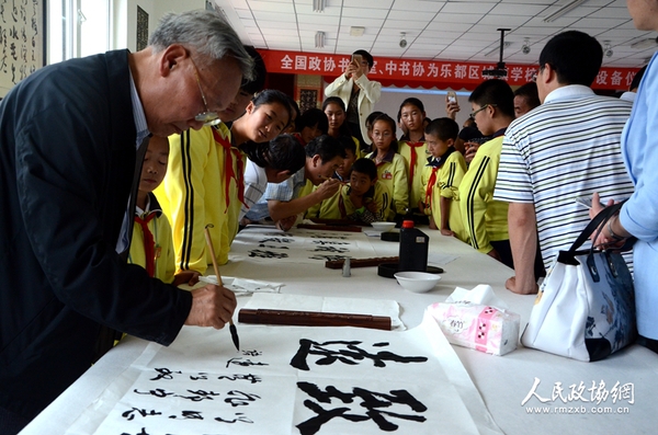 圖片說明： 書畫室委員與學(xué)生共同創(chuàng)作書法作品。